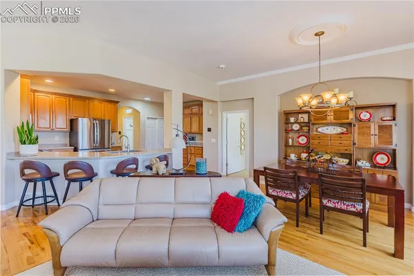 a living room with furniture a chandelier and a large window