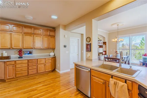a large kitchen with stainless steel appliances granite countertop a sink and dishwasher with wooden floor