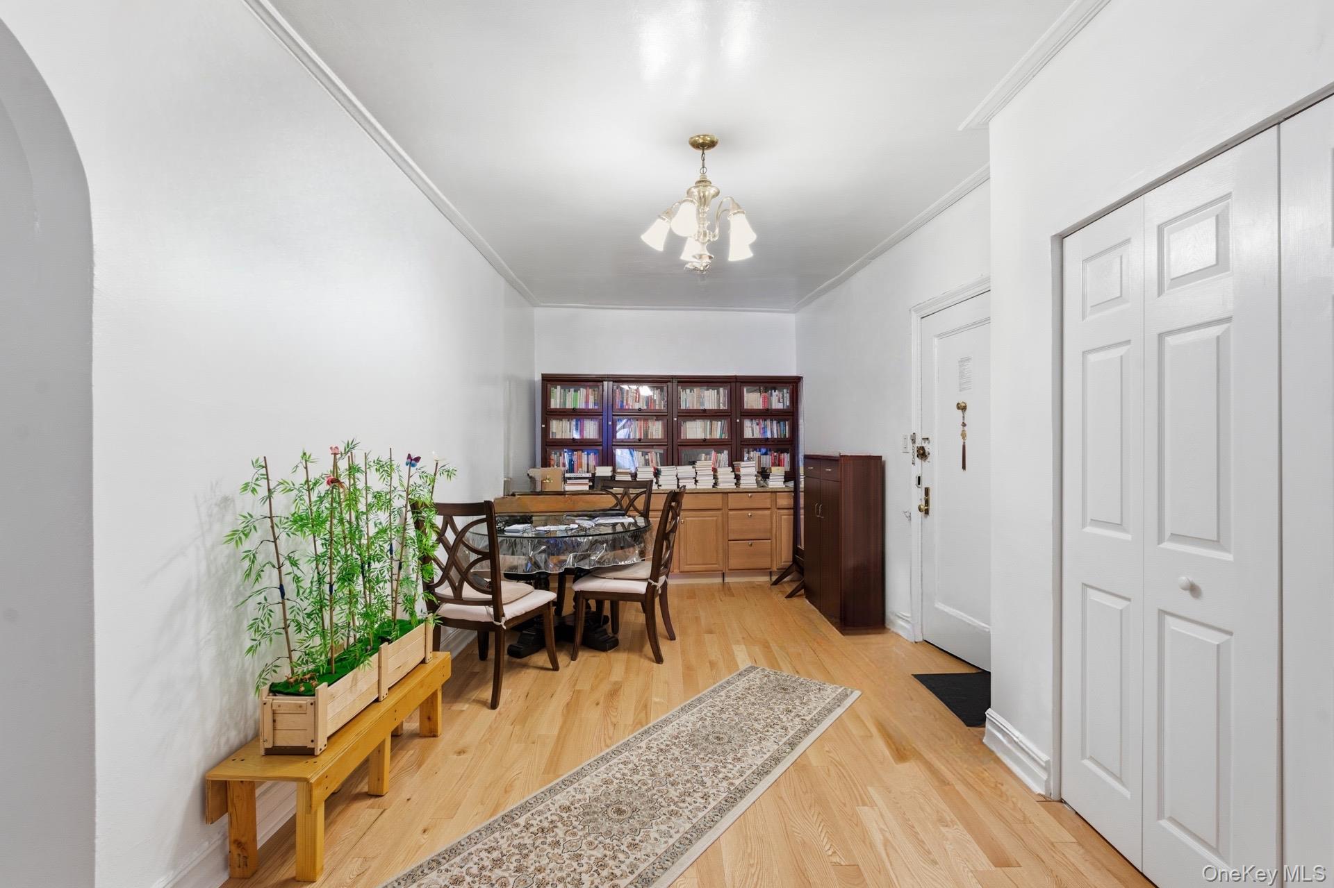 88-11 Elmhurst Avenue, Unit B6 Queens, NY 11373 - Photo 4 of 15 a dining room with furniture a rug and wooden floor