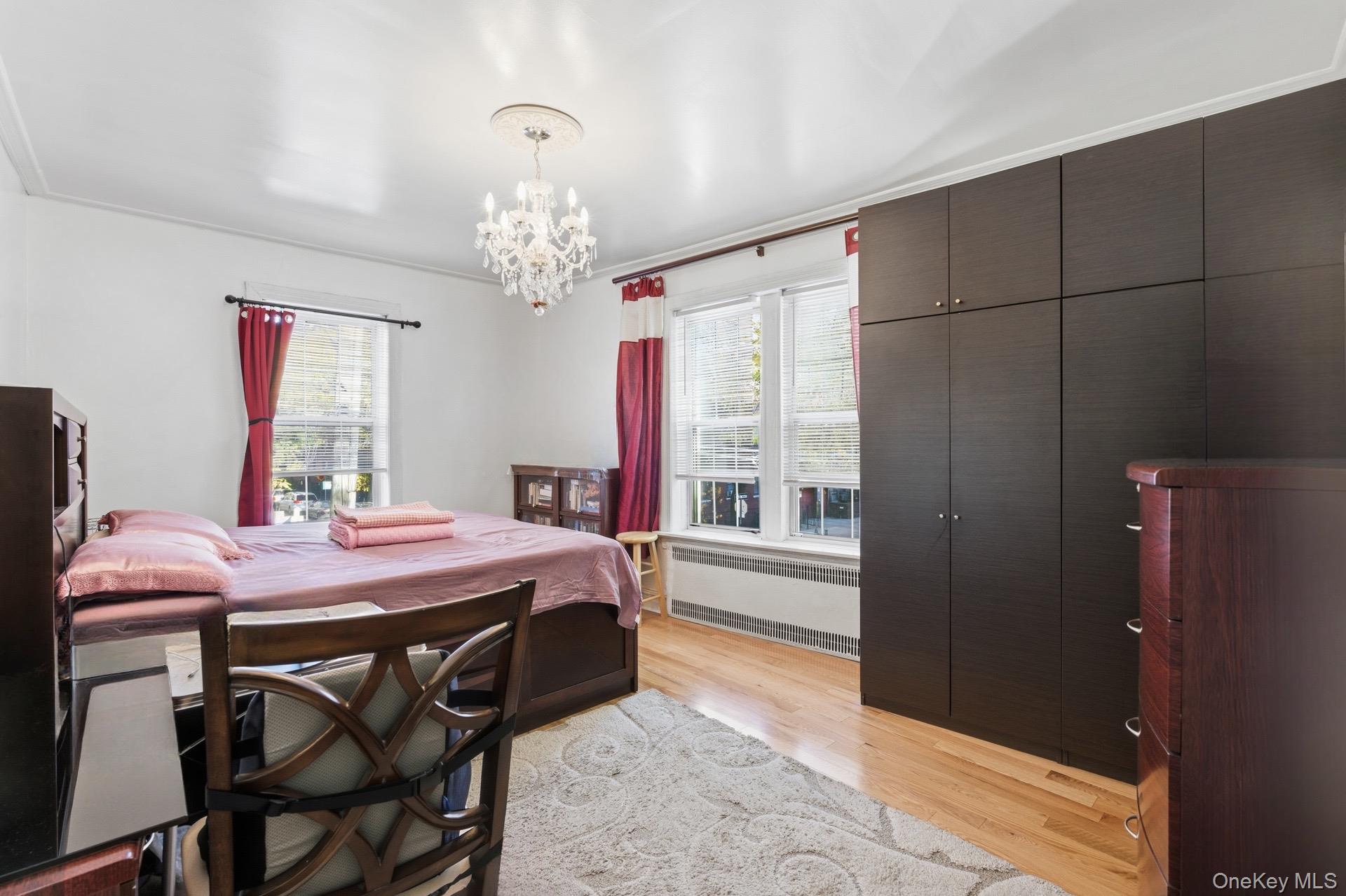 88-11 Elmhurst Avenue, Unit B6 Queens, NY 11373 - Photo 9 of 15 a dining room with a table and chairs