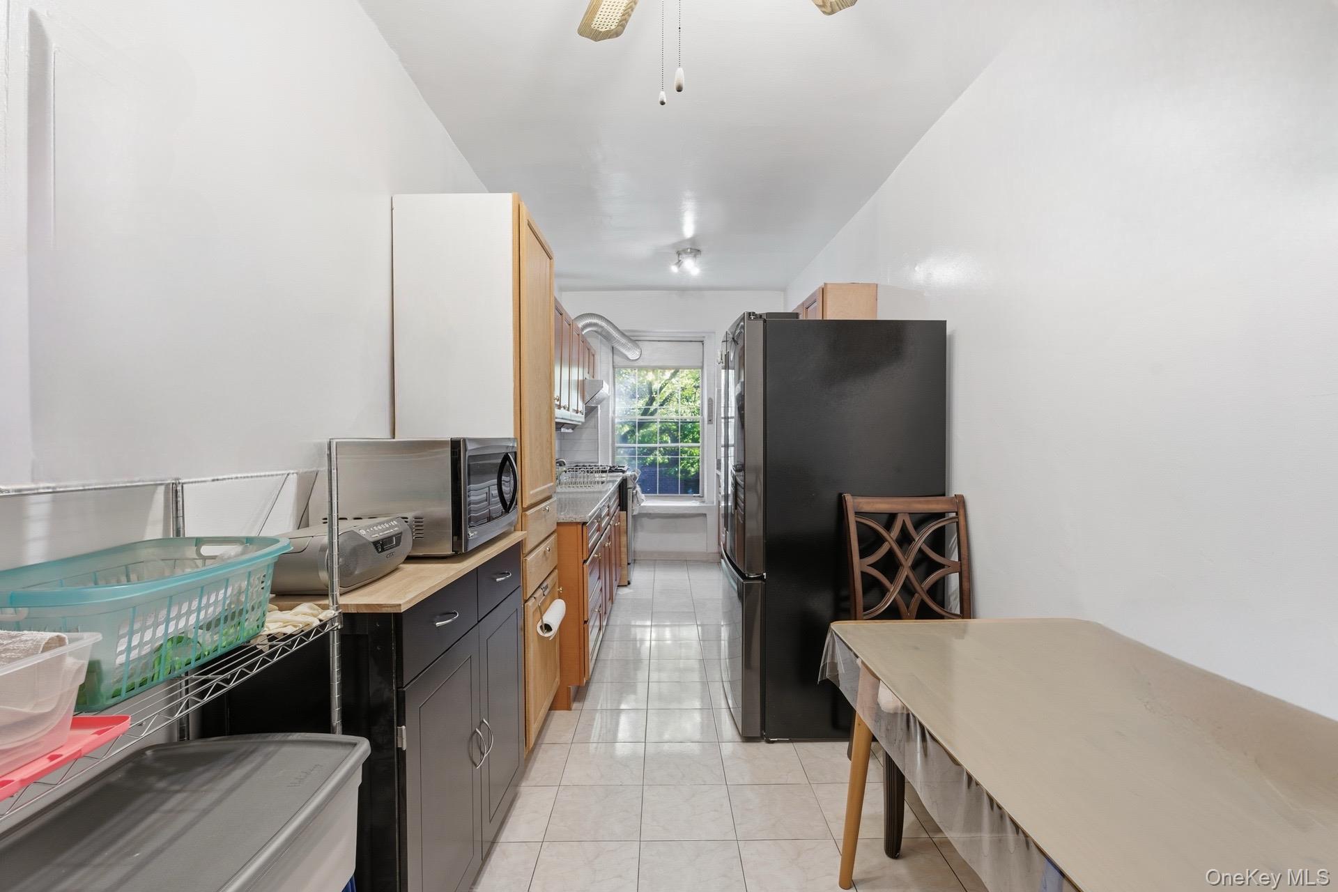 88-11 Elmhurst Avenue, Unit B6 Queens, NY 11373 - Photo 10 of 15 a kitchen with a refrigerator and a stove