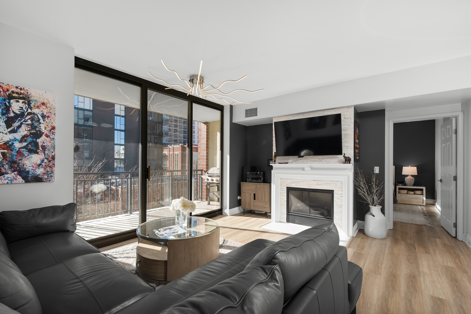 55 West Delaware Place, Unit 614 Chicago, IL 60610 - Photo 2 of 21 a living room with furniture a flat screen tv and a fireplace