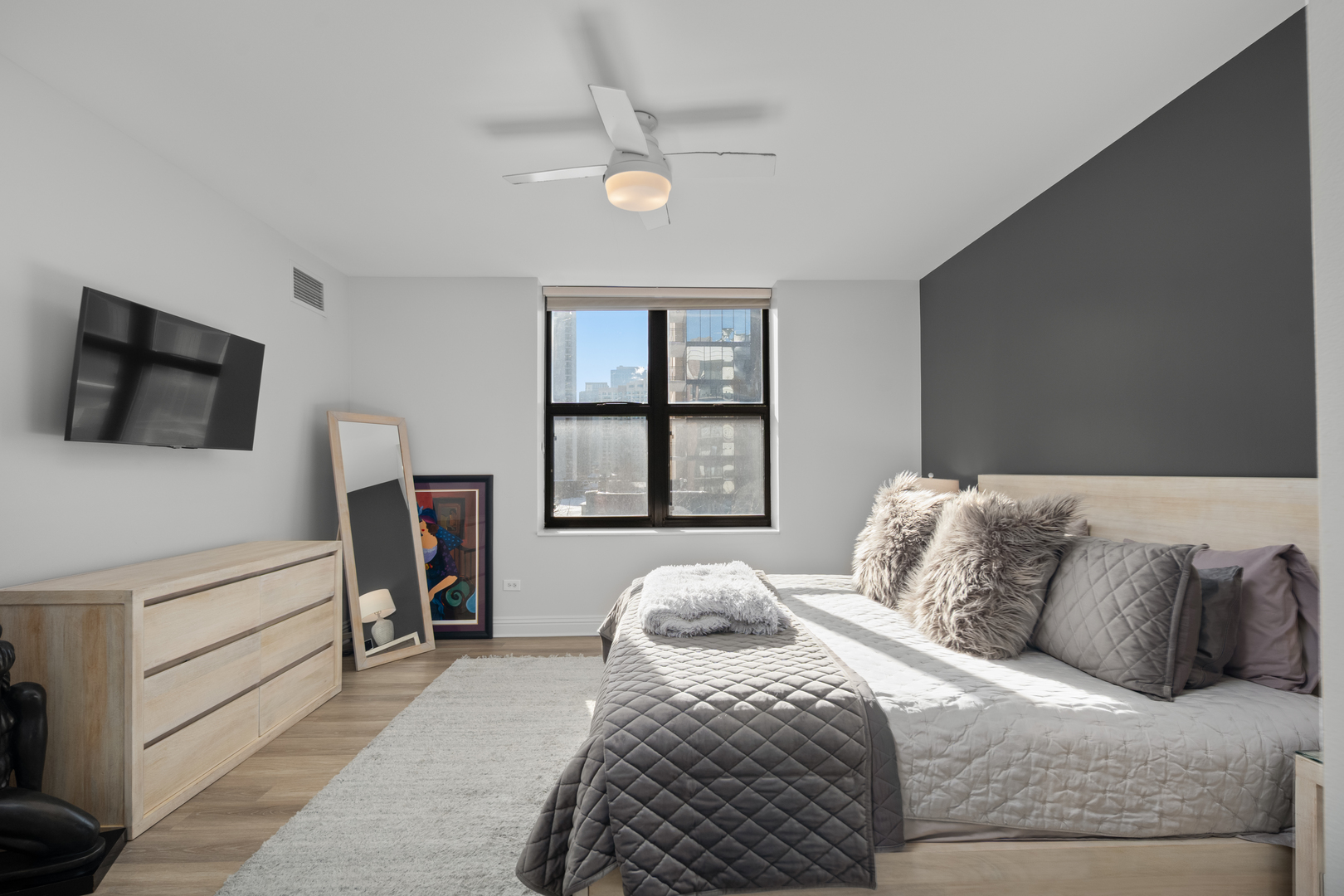 55 West Delaware Place, Unit 614 Chicago, IL 60610 - Photo 10 of 21 a bedroom with a bed and a flat screen tv