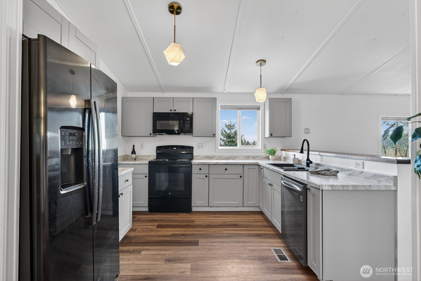 63 North Cross Island Road Camano Island, WA 98282 - Photo 11 of 23 a kitchen with a sink stainless steel appliances and cabinets