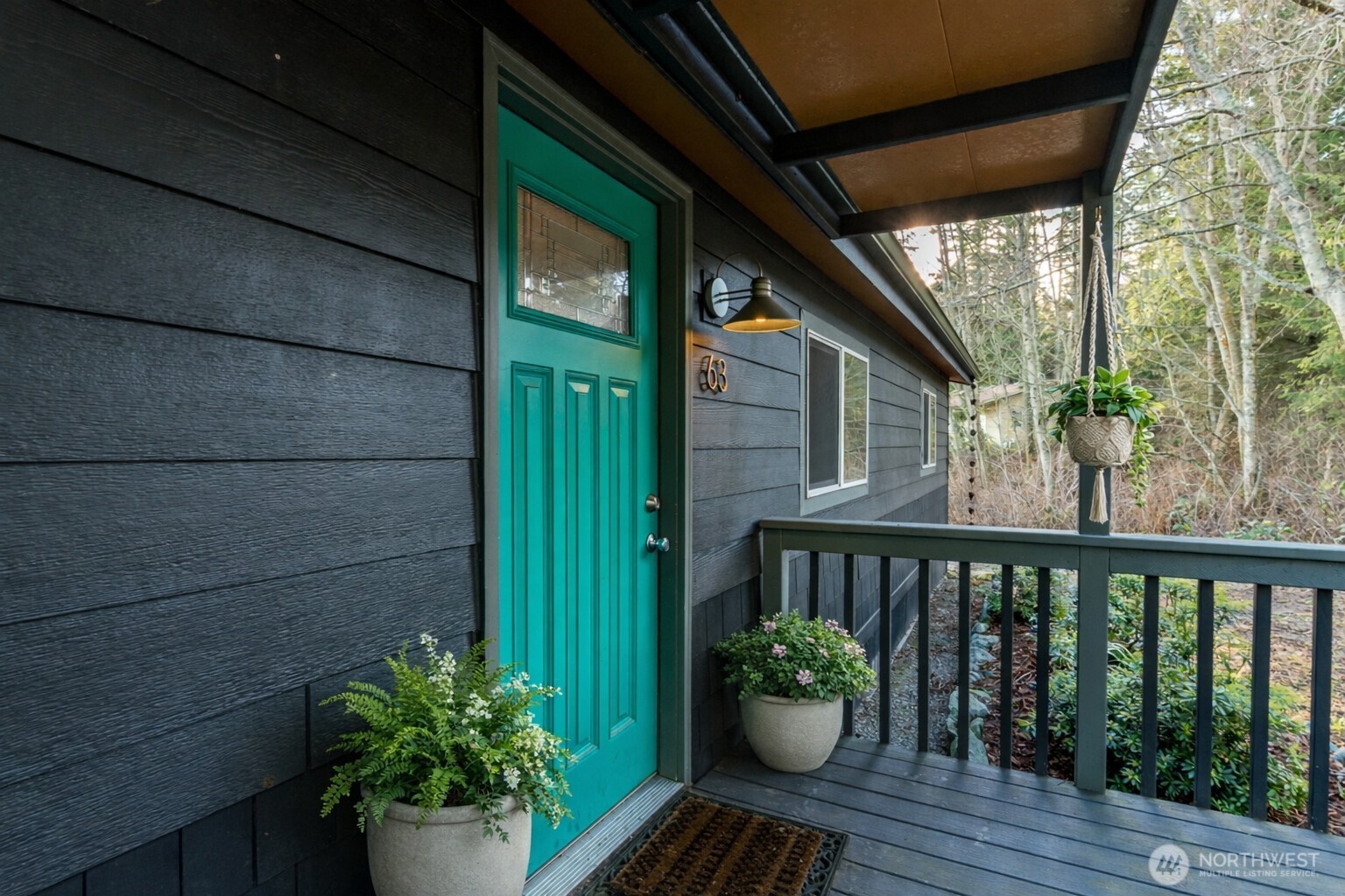 63 North Cross Island Road Camano Island, WA 98282 - Photo 3 of 23 a balcony with potted plants and wooden floor