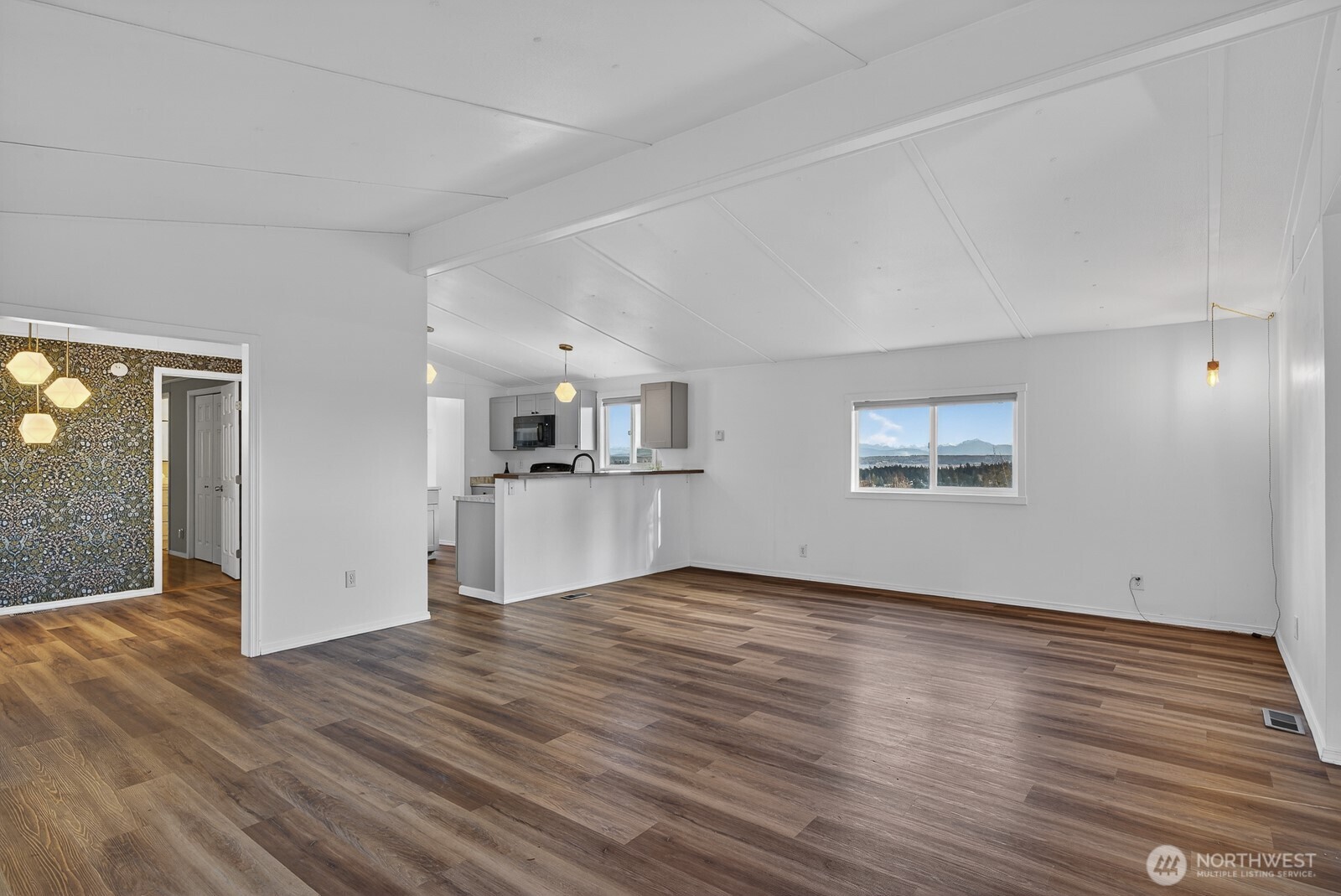 63 North Cross Island Road Camano Island, WA 98282 - Photo 7 of 23 an empty room with wooden floor and windows