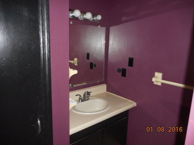 4602 Bishop Road Macon, GA 31206 - Photo 11 of 11 a bathroom with a sink a mirror and a toilet