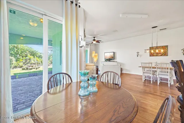 a kitchen with stainless steel appliances granite countertop a stove a sink dishwasher and a microwave with wooden floor