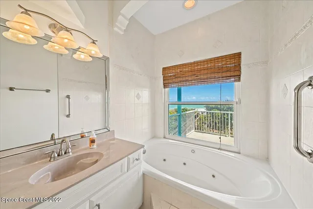 a bedroom with 2 bed and a large window