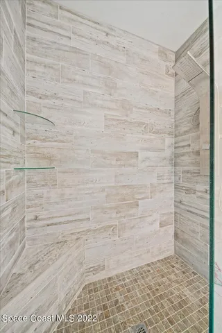 a bed room with a bed and a chandelier