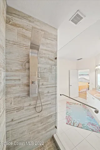 a spacious bedroom with a bed and wooden floor