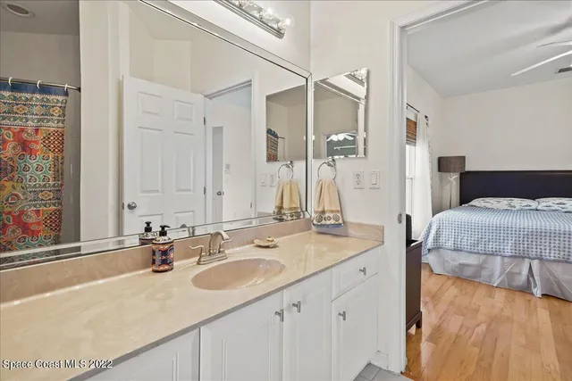 a backyard of a house with lots of green space and wooden fence