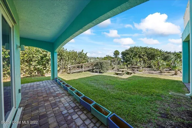 a view of a house with a yard and sitting area