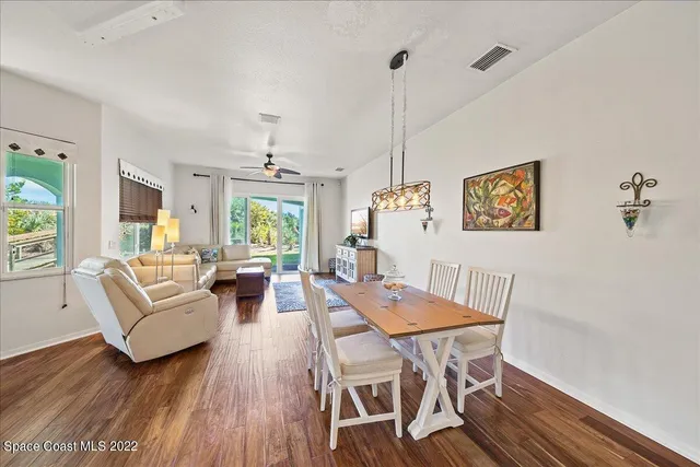 a view of a dining room with furniture window and wooden floor