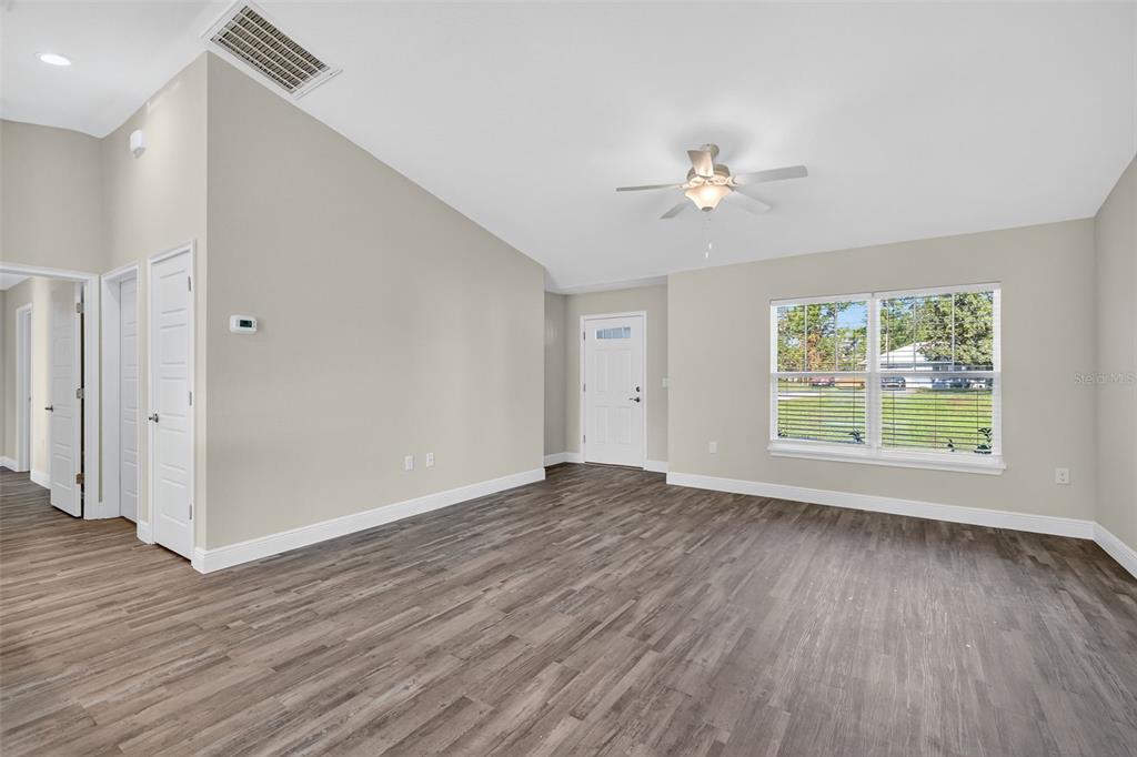 9 Chestnut Run Ocala, FL 34480 - Photo 8 of 17 a view of an empty room with wooden floor and a window