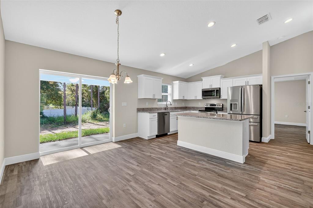9 Chestnut Run Ocala, FL 34480 - Photo 10 of 17 a kitchen with refrigerator and wooden floor