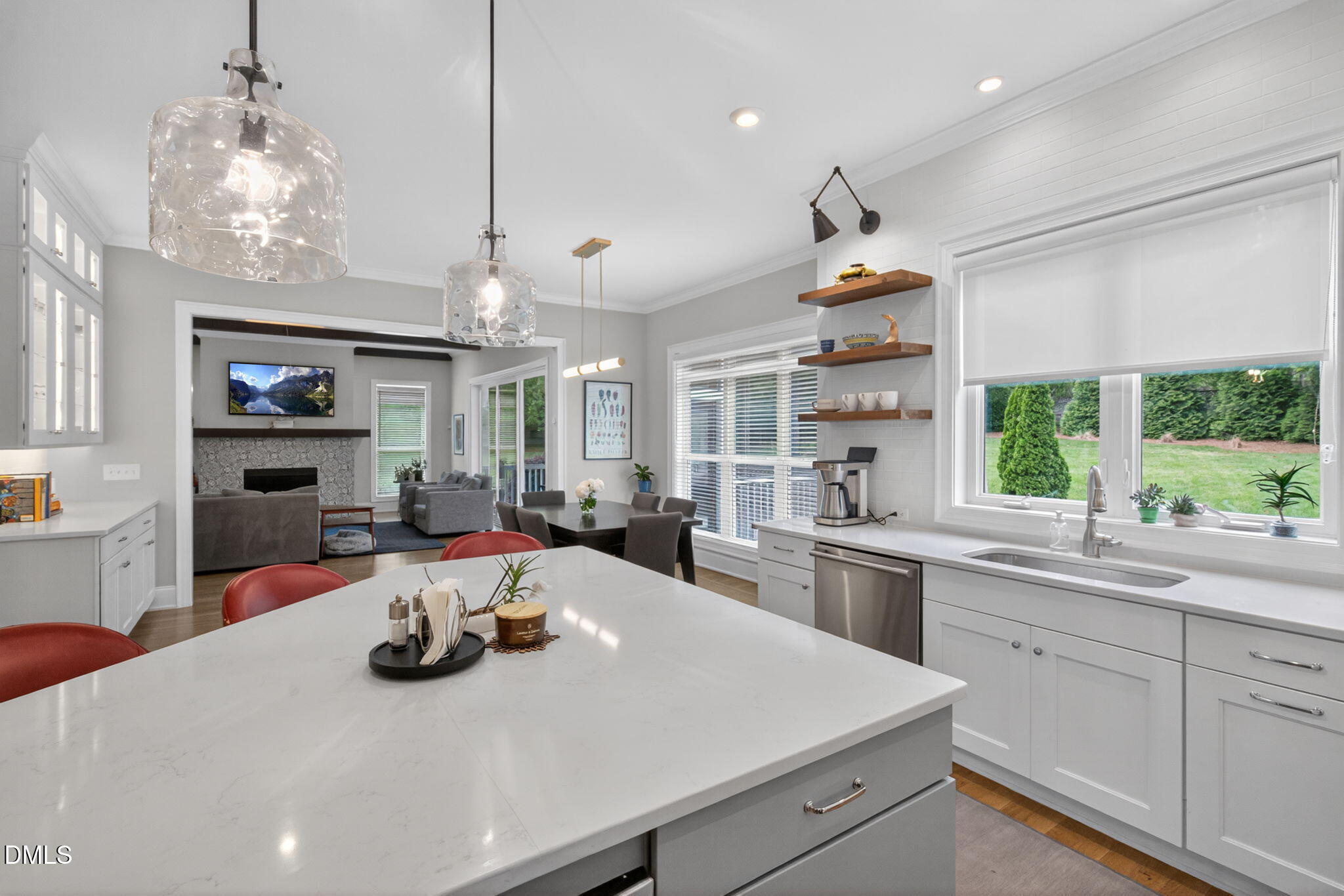 6901 Ray Family Farm Court Raleigh, NC 27613 - Photo 14 of 52 a kitchen with a sink a stove and chairs