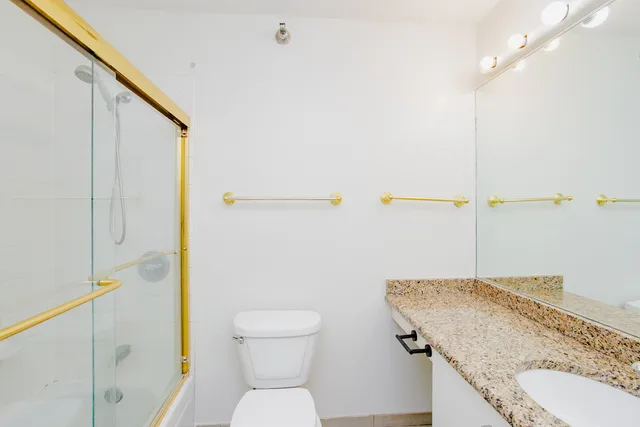a view of hallway with closet and chandelier fan
