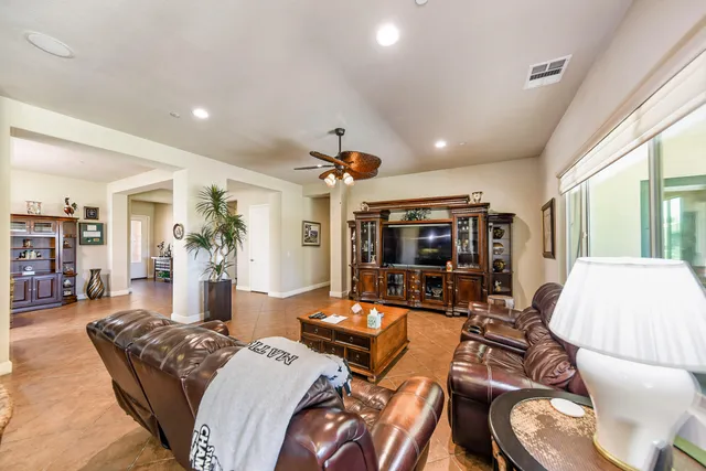 a living room with furniture and dining room