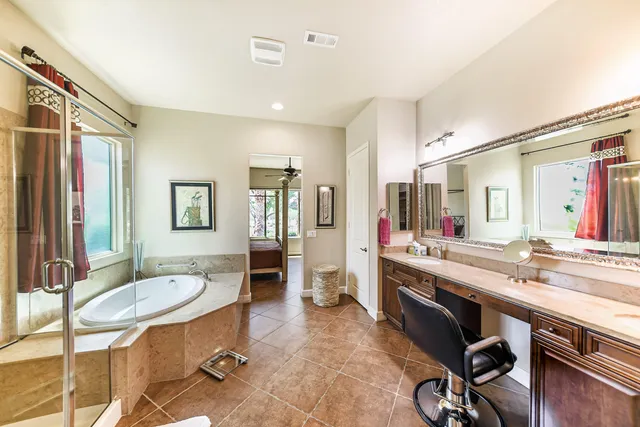a large bathroom with a sink double vanity granite and a mirror