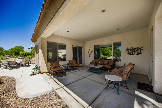 a view of a house with backyard and sitting area