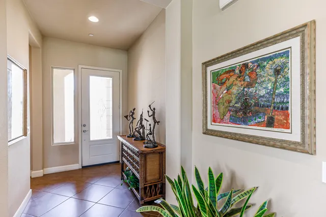 a view of a hallway with wooden floor and a potted plant