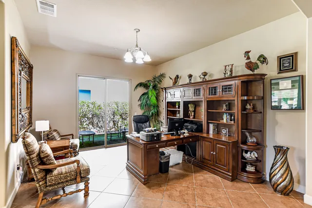 a living room with furniture and a book shelf