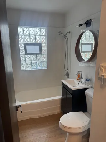 a bathroom with a toilet a sink and a mirror