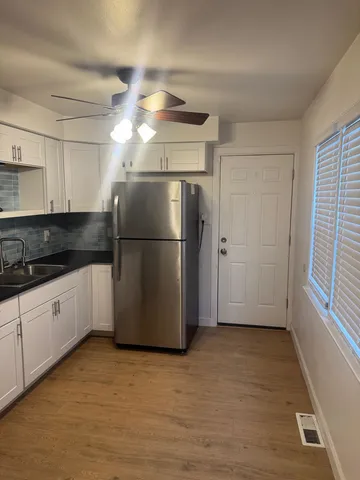 a kitchen with stainless steel appliances granite countertop a refrigerator a sink a stove a microwave a sink and dishwasher