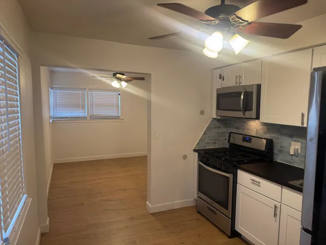 a kitchen with granite countertop a stove and a refrigerator