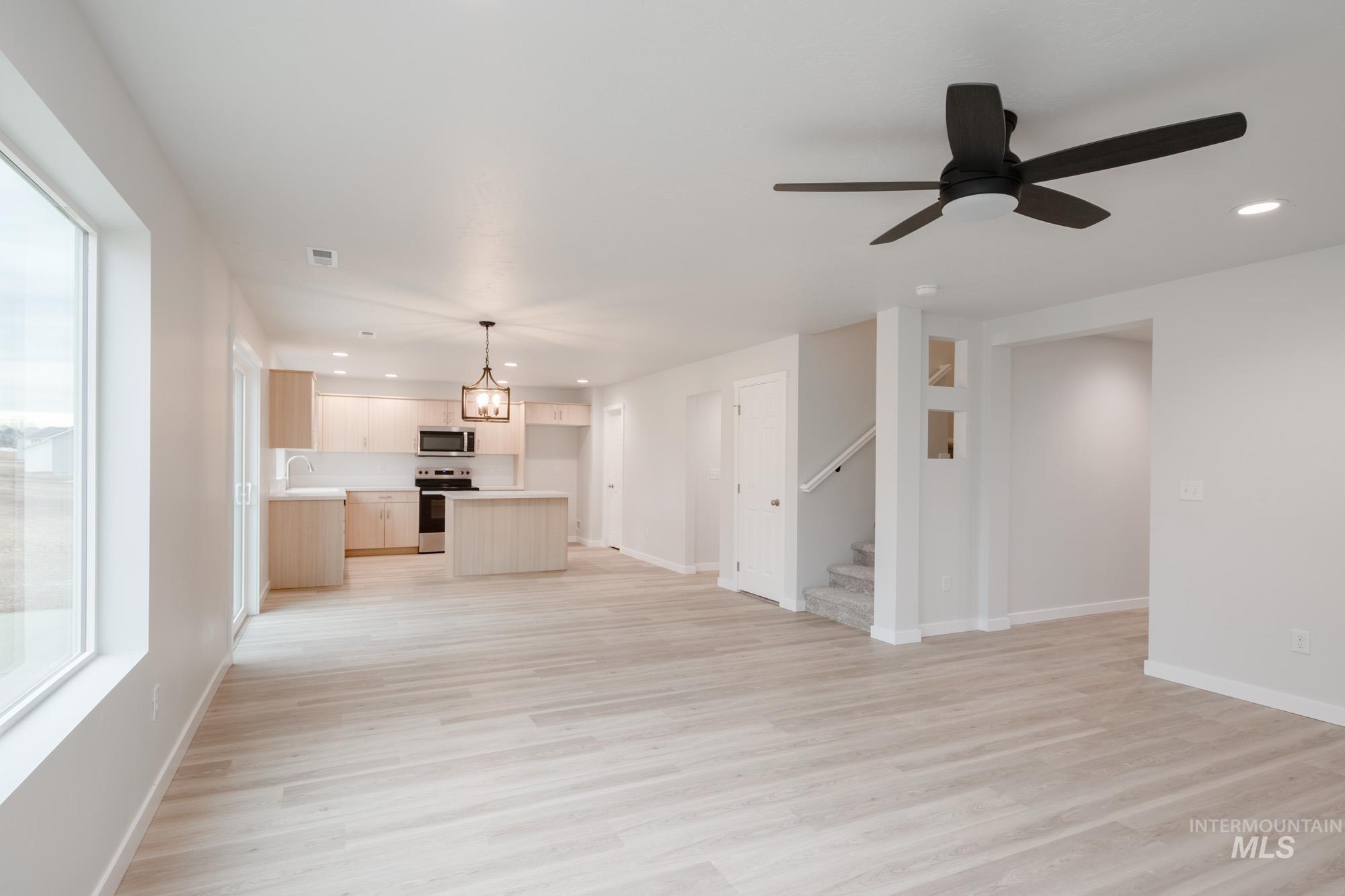 1472 Long Pond Street Middleton, ID 83644 - Photo 11 of 21 Unfurnished living room with recessed lighting, light wood-style floors, stairs, and a ceiling fan