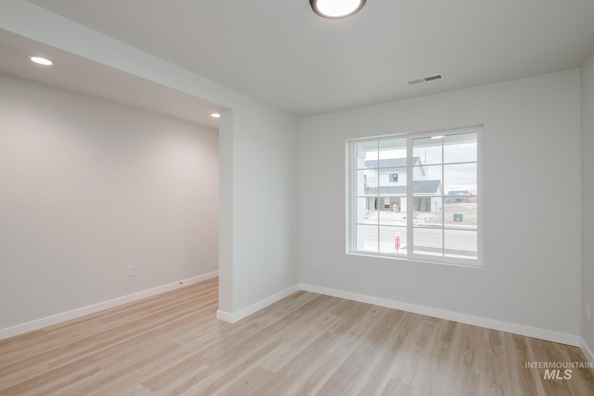 1472 Long Pond Street Middleton, ID 83644 - Photo 12 of 21 Empty room with light wood finished floors and recessed lighting
