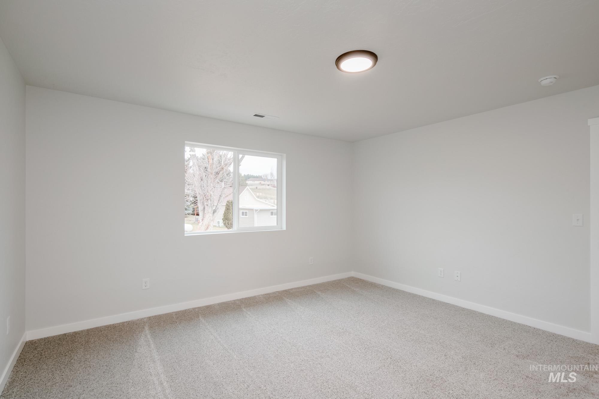 1472 Long Pond Street Middleton, ID 83644 - Photo 13 of 21 Unfurnished room featuring light colored carpet and baseboards