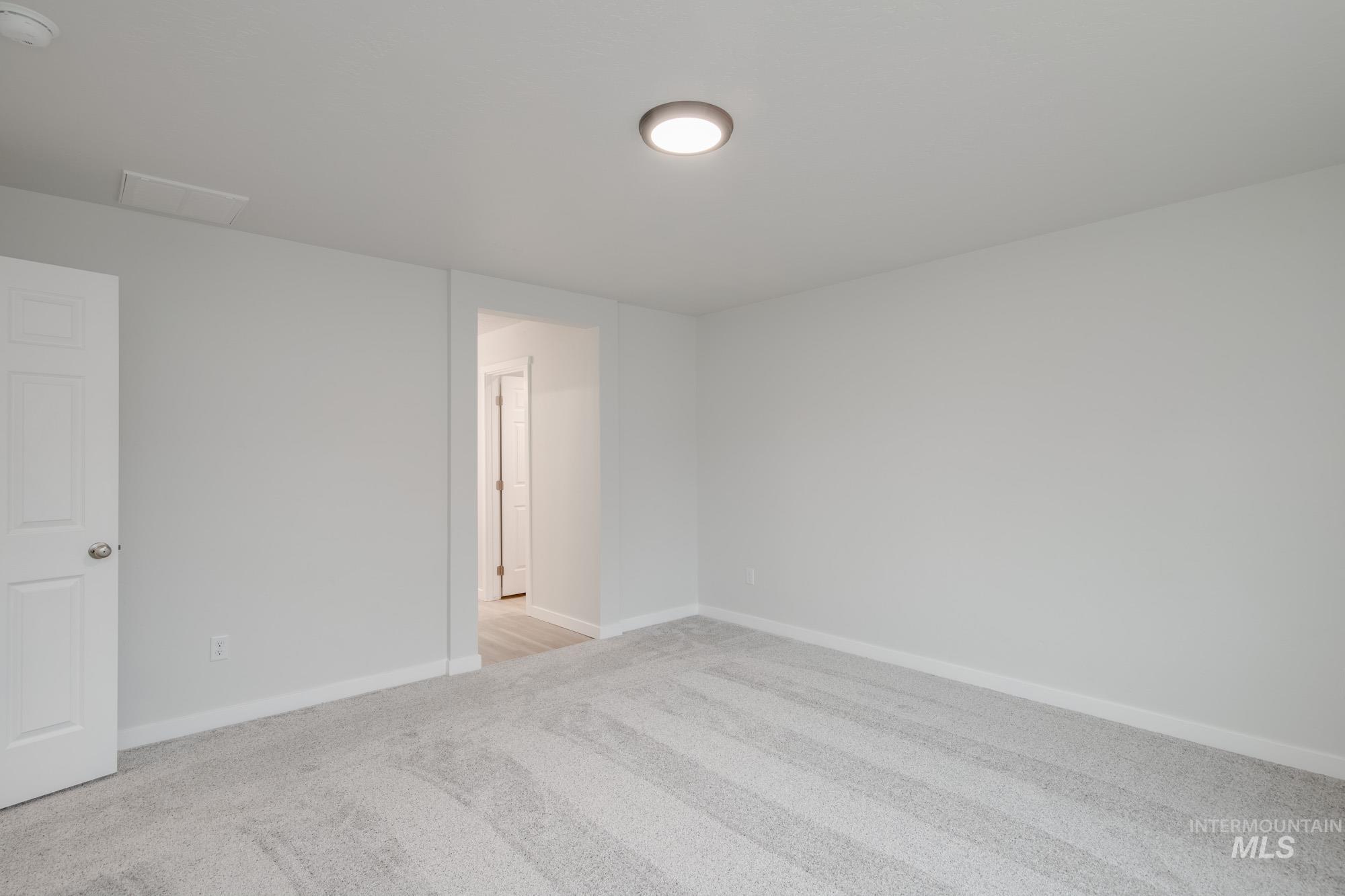 1472 Long Pond Street Middleton, ID 83644 - Photo 14 of 21 Empty room with light carpet and a smoke detector