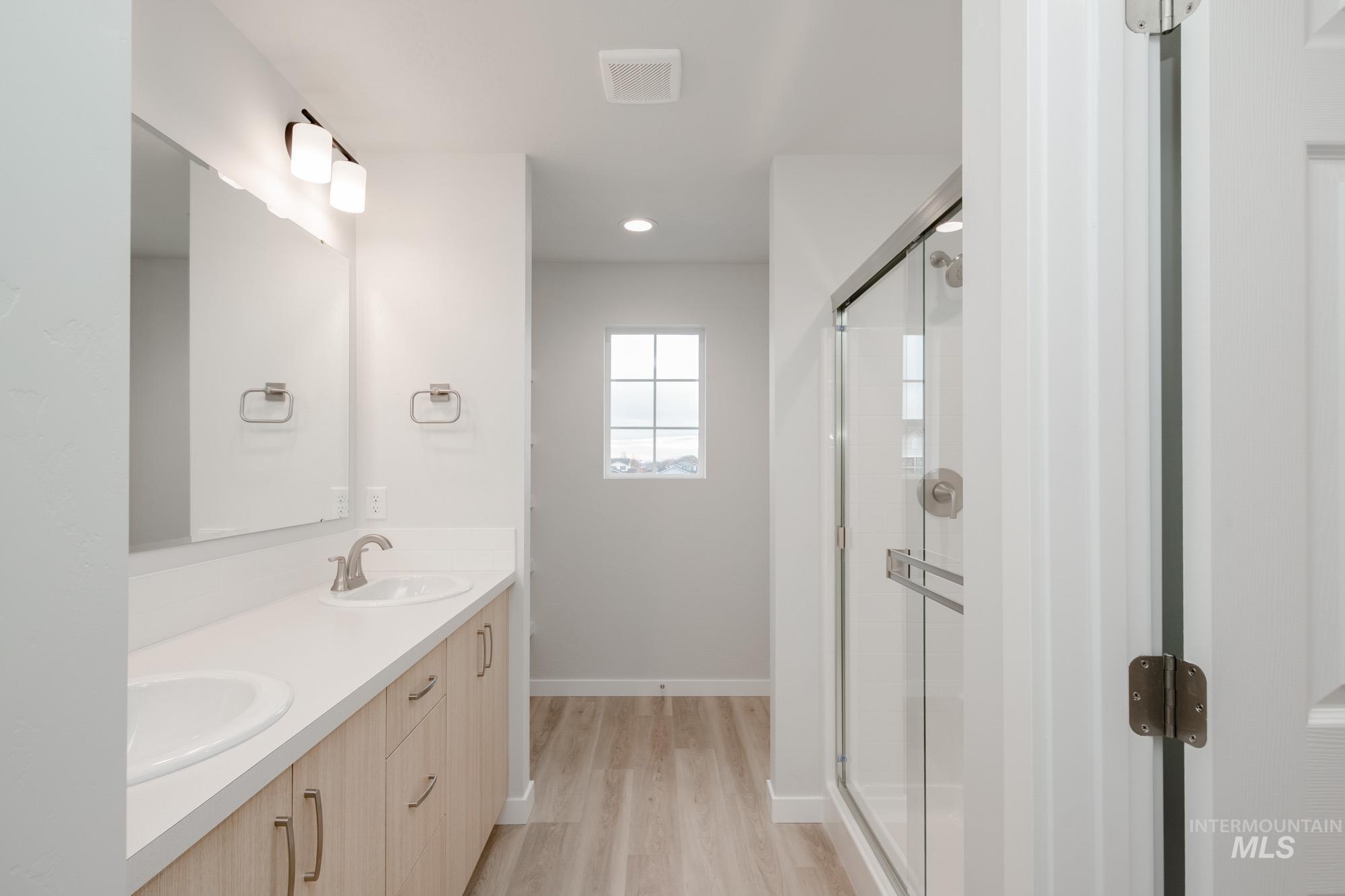 1472 Long Pond Street Middleton, ID 83644 - Photo 15 of 21 Full bathroom featuring double vanity, a stall shower, light wood-style floors, and recessed lighting