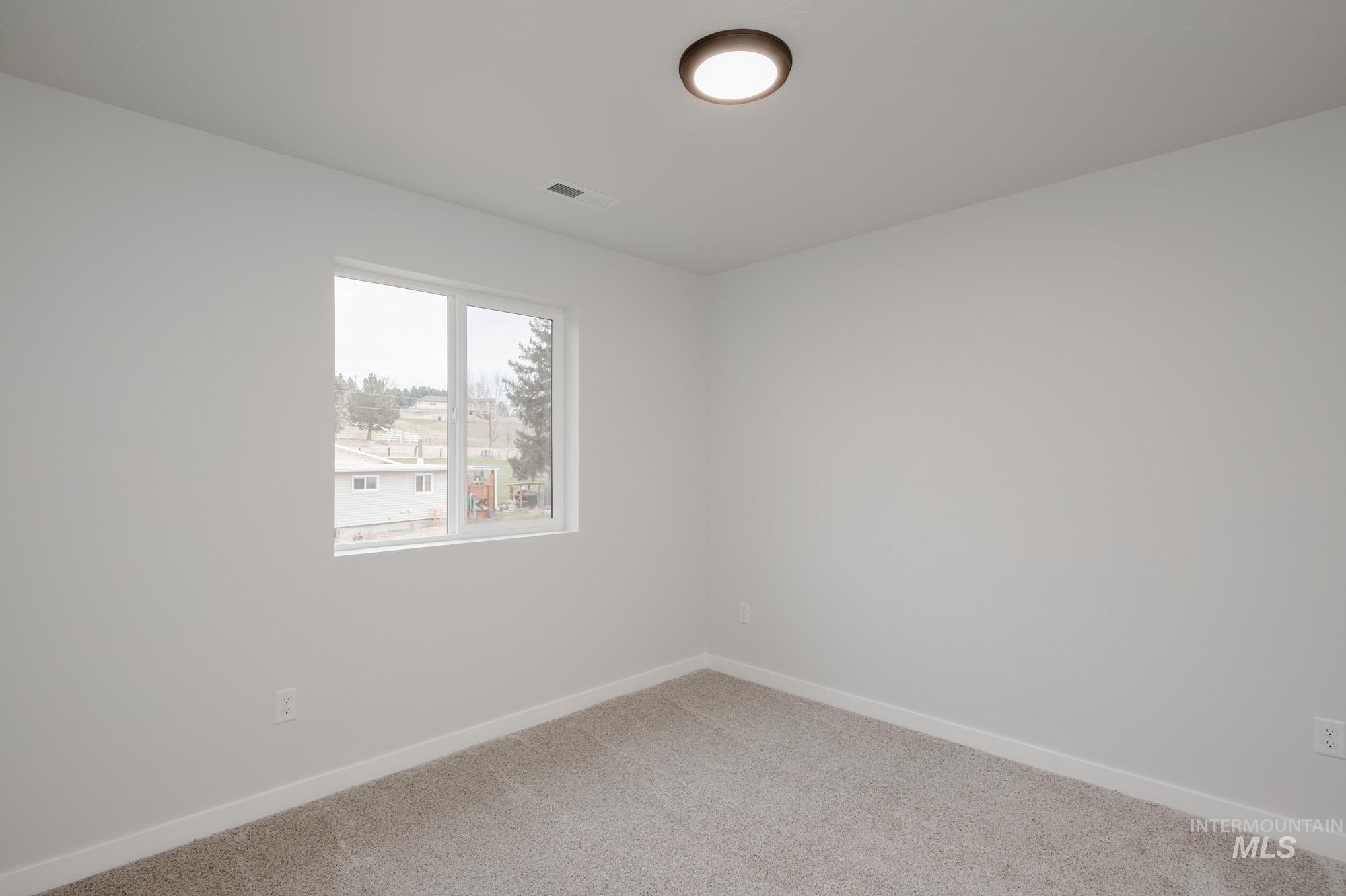 1472 Long Pond Street Middleton, ID 83644 - Photo 17 of 21 Spare room with baseboards and carpet flooring