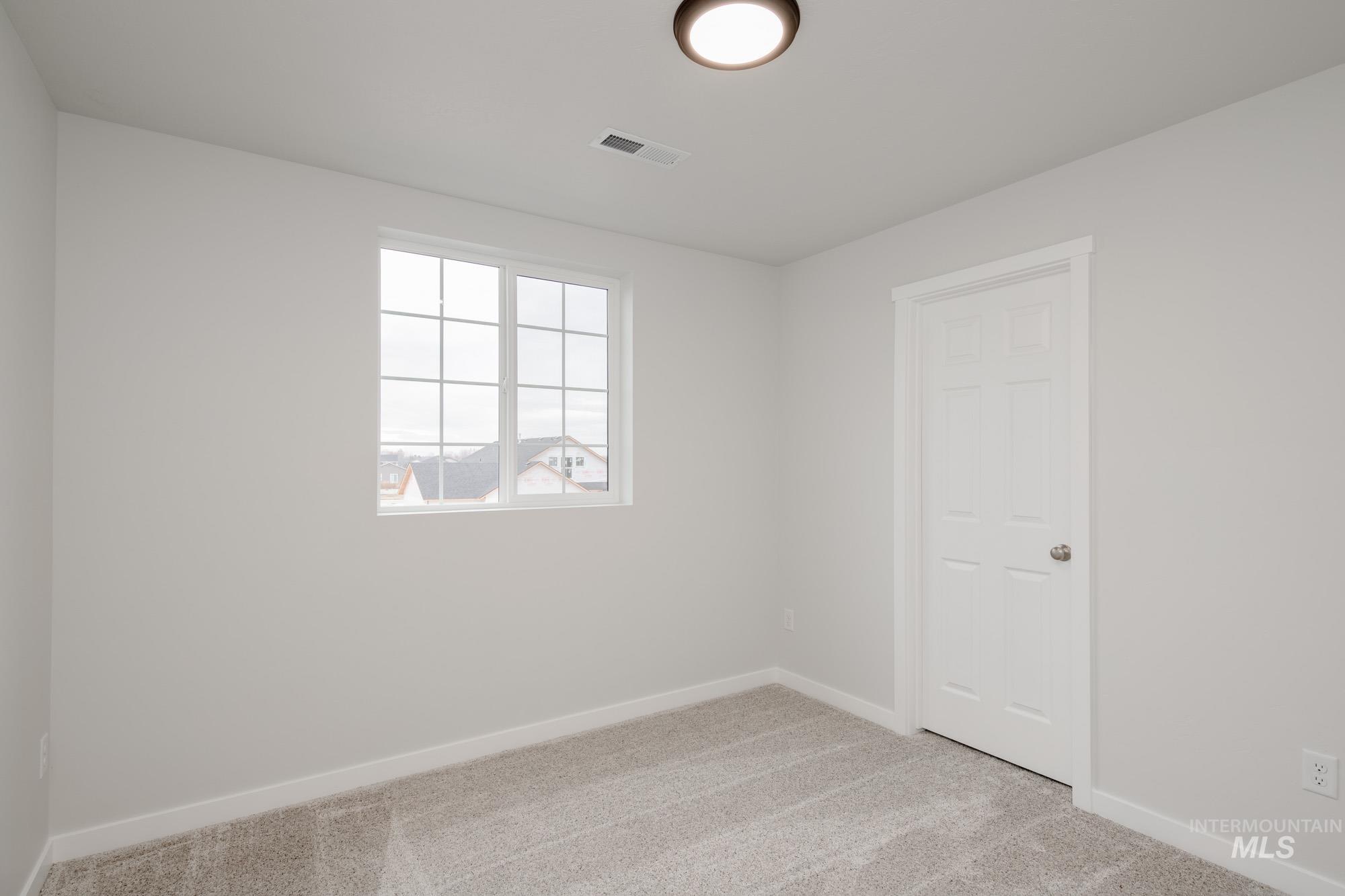 1472 Long Pond Street Middleton, ID 83644 - Photo 18 of 21 Unfurnished room with light colored carpet and baseboards