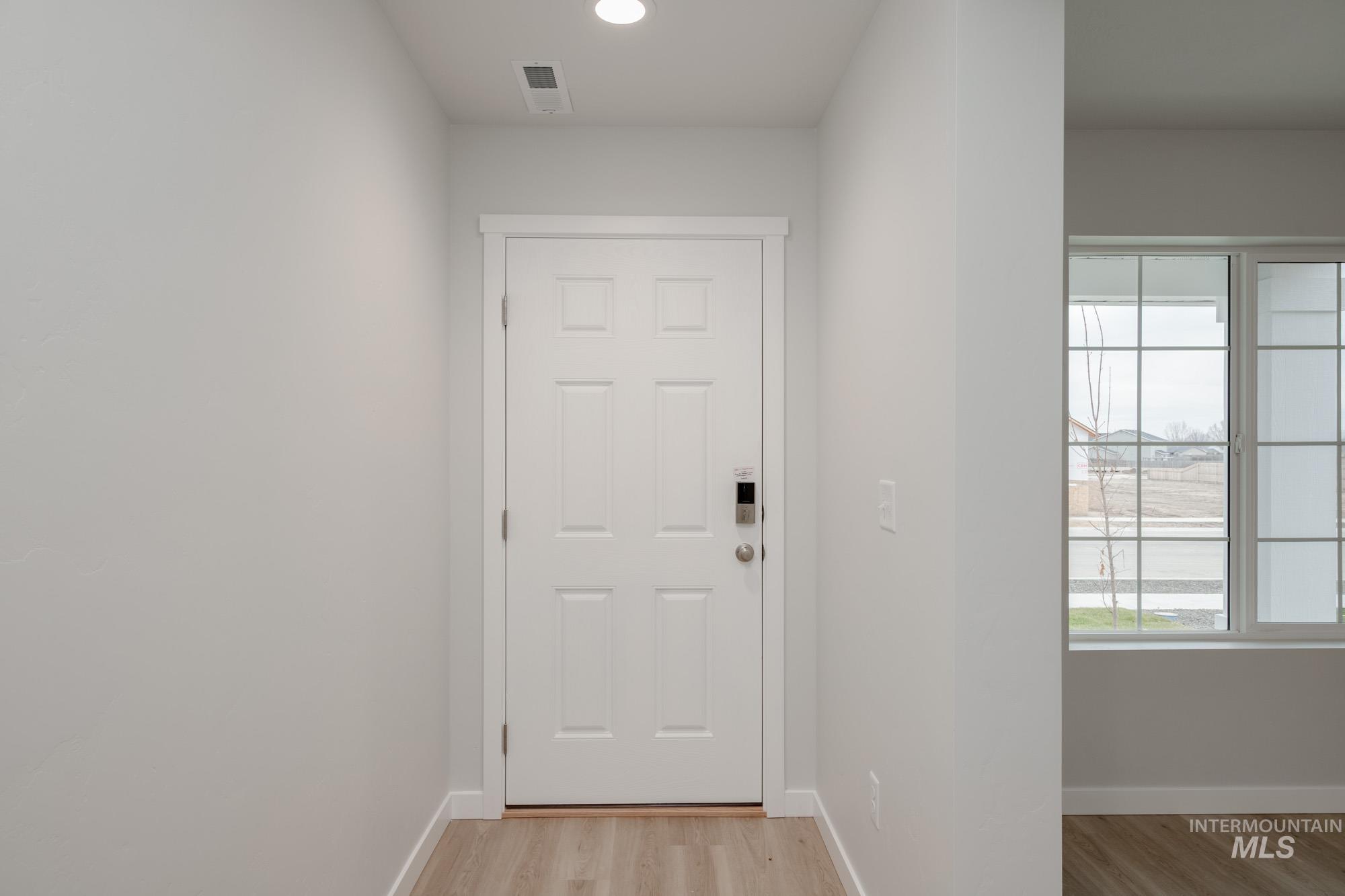 1472 Long Pond Street Middleton, ID 83644 - Photo 2 of 21 Doorway to outside with healthy amount of natural light and wood finished floors
