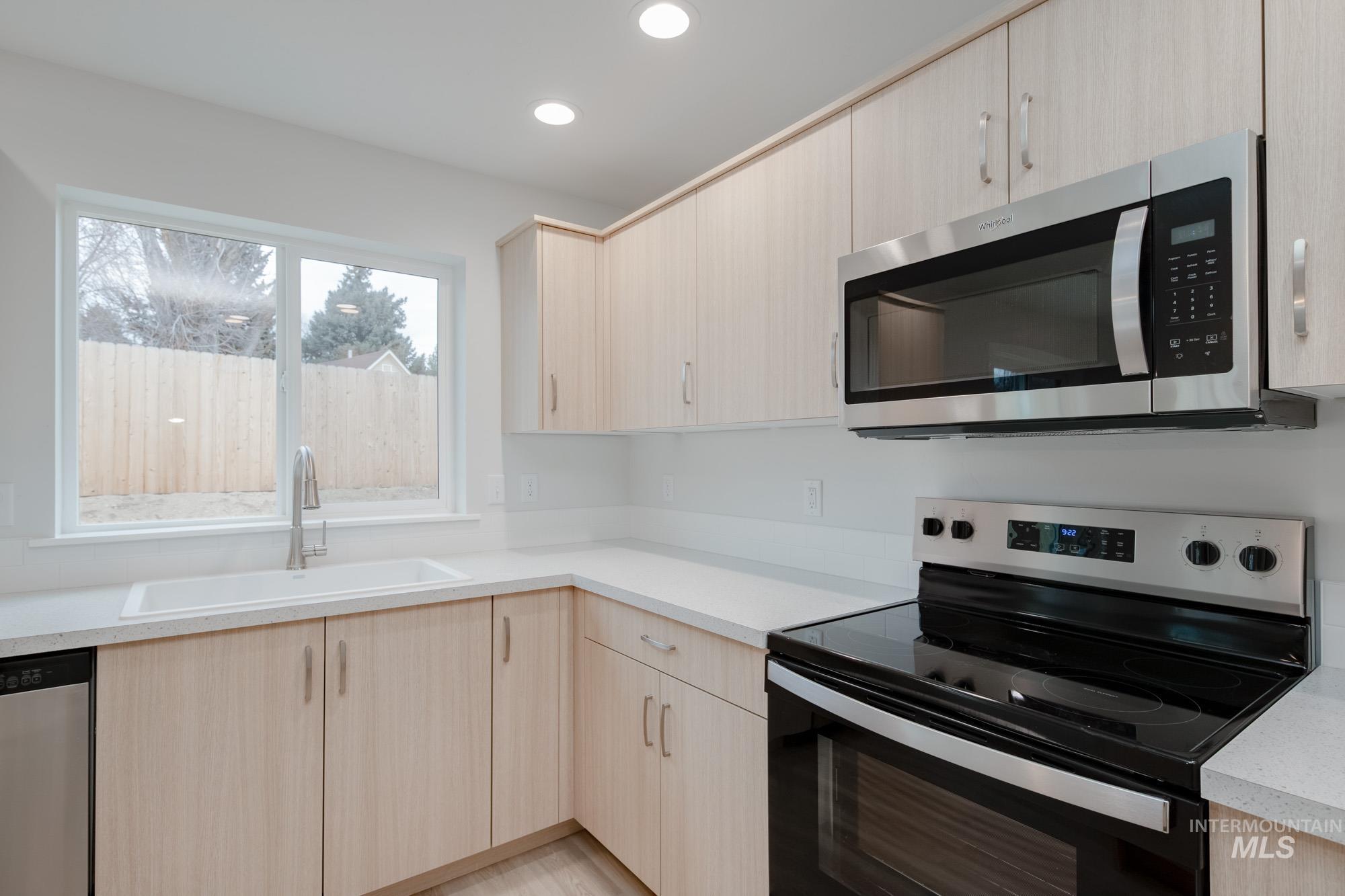 1472 Long Pond Street Middleton, ID 83644 - Photo 6 of 21 Kitchen featuring light brown cabinets, stainless steel appliances, light countertops, recessed lighting, and modern cabinets