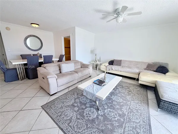 a living room with furniture and a rug