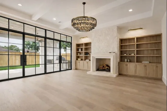a view of an empty room with a fireplace and a window