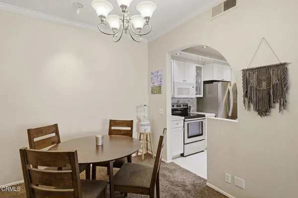 a kitchen with a sink a stove and cabinets