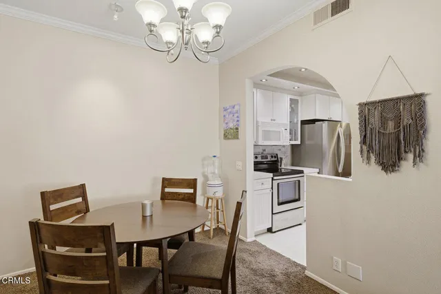a kitchen with a sink a stove and cabinets