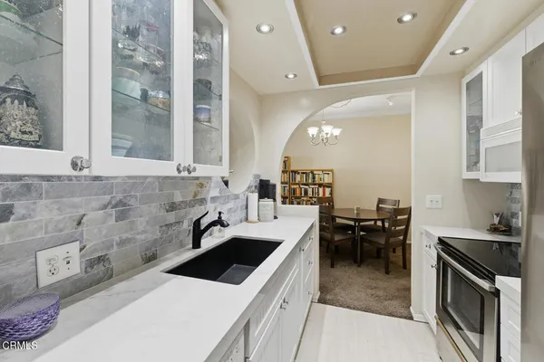 a kitchen with a stove a refrigerator and a sink