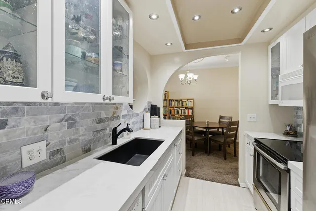 a kitchen with a stove a refrigerator and a sink