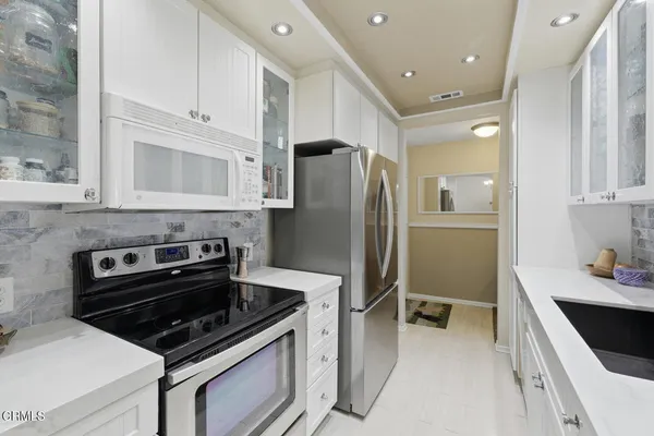 a kitchen with a sink and cabinets
