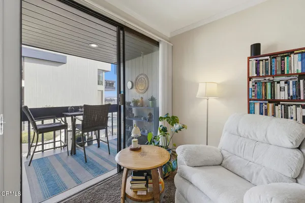 a living room with furniture and a book shelf