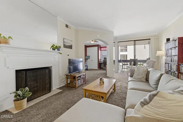 a living room with fireplace furniture and a book shelf