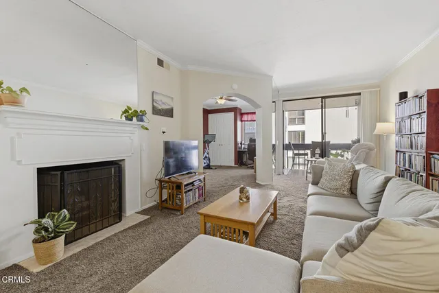 a living room with fireplace furniture and a book shelf