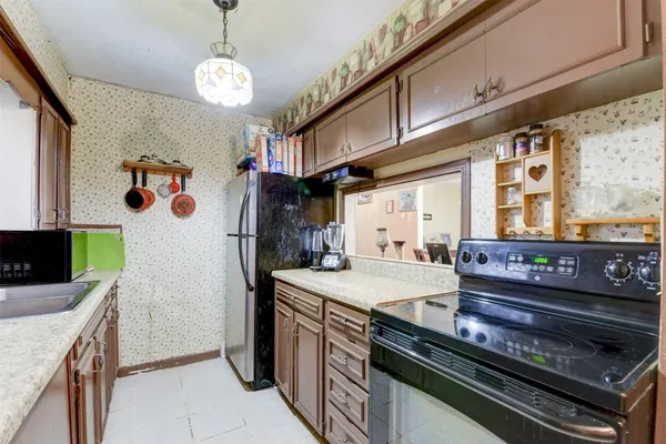 a kitchen with a stove and a refrigerator